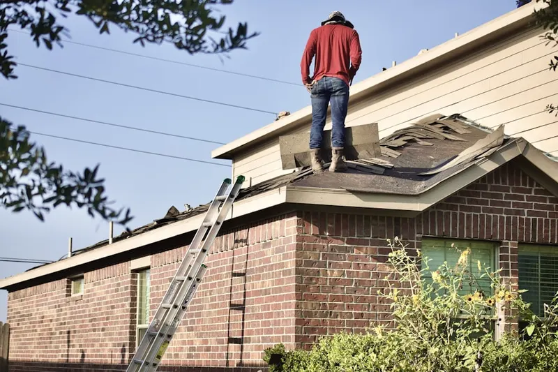 Professional roofer working on a residential roof in North Patchogue